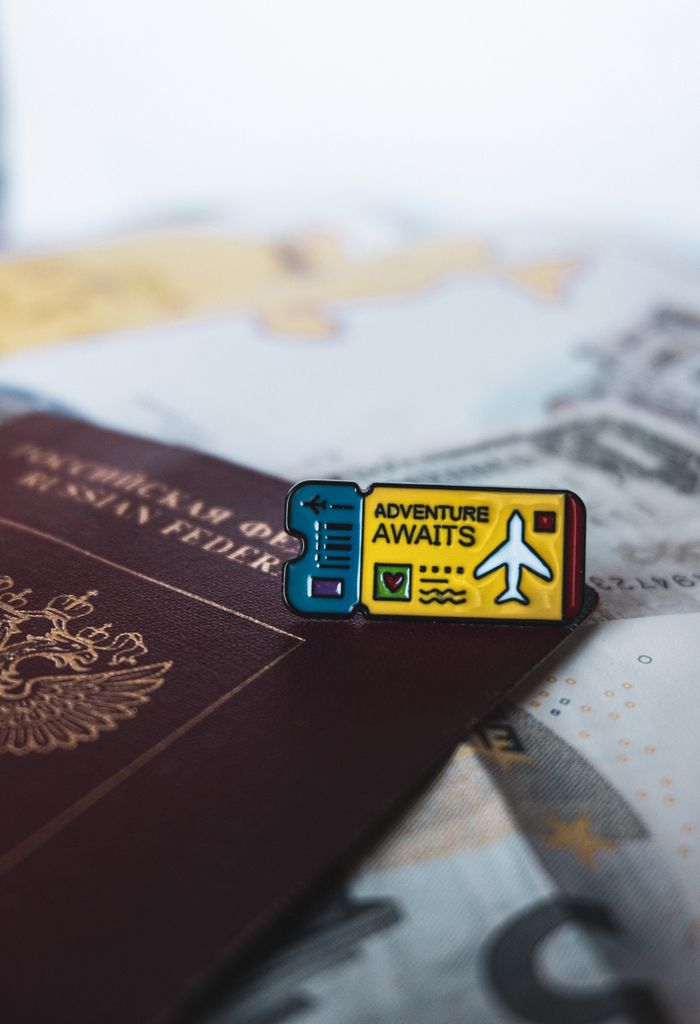 Crafting Captivating Headlines: Your awesome post title goes here A Russian passport with an 'Adventure Awaits' pin symbolizes travel and exploration.